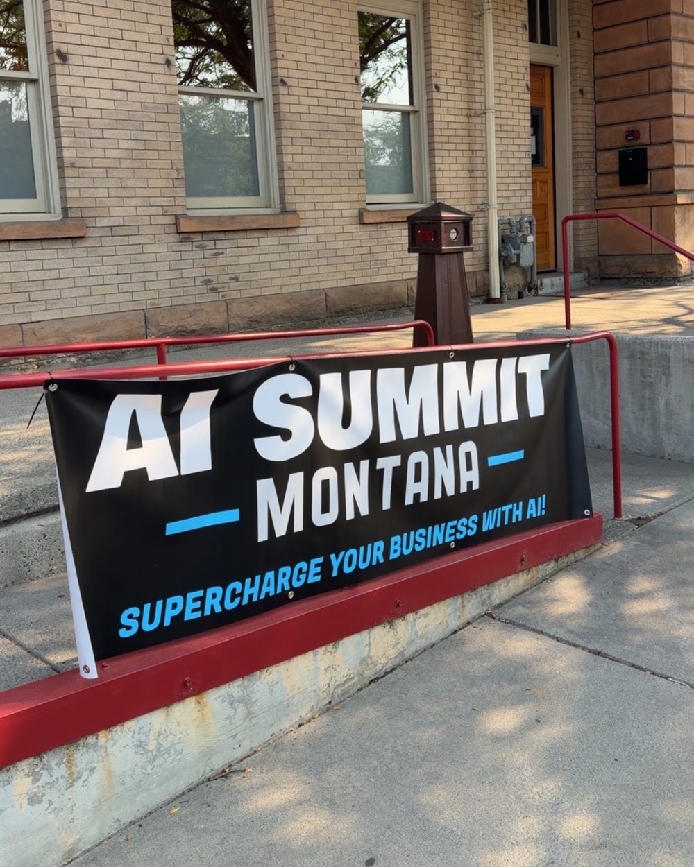 AI Summit Montana banner on the steps of the Billings Depot